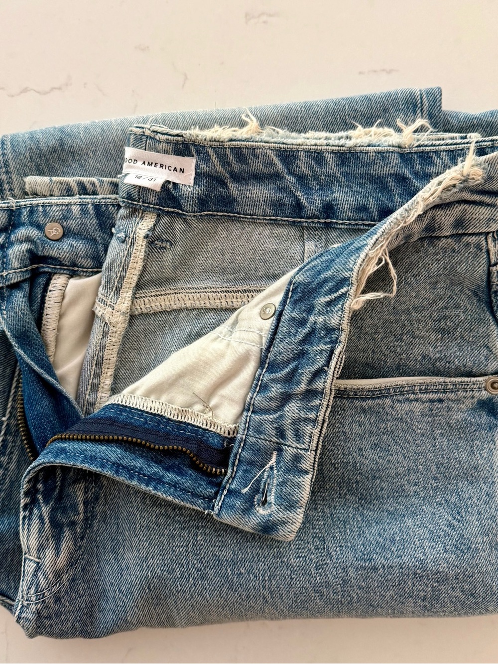 Good American Light Wash Straight Leg Jeans with Frayed Waist & Side Split Ankle